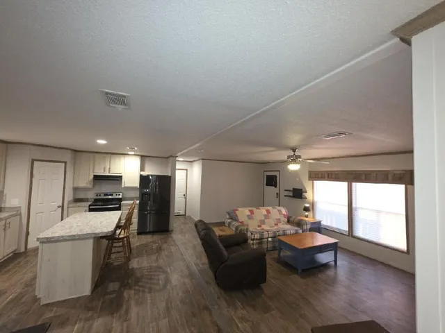 a kitchen with a refrigerator and a stove top oven