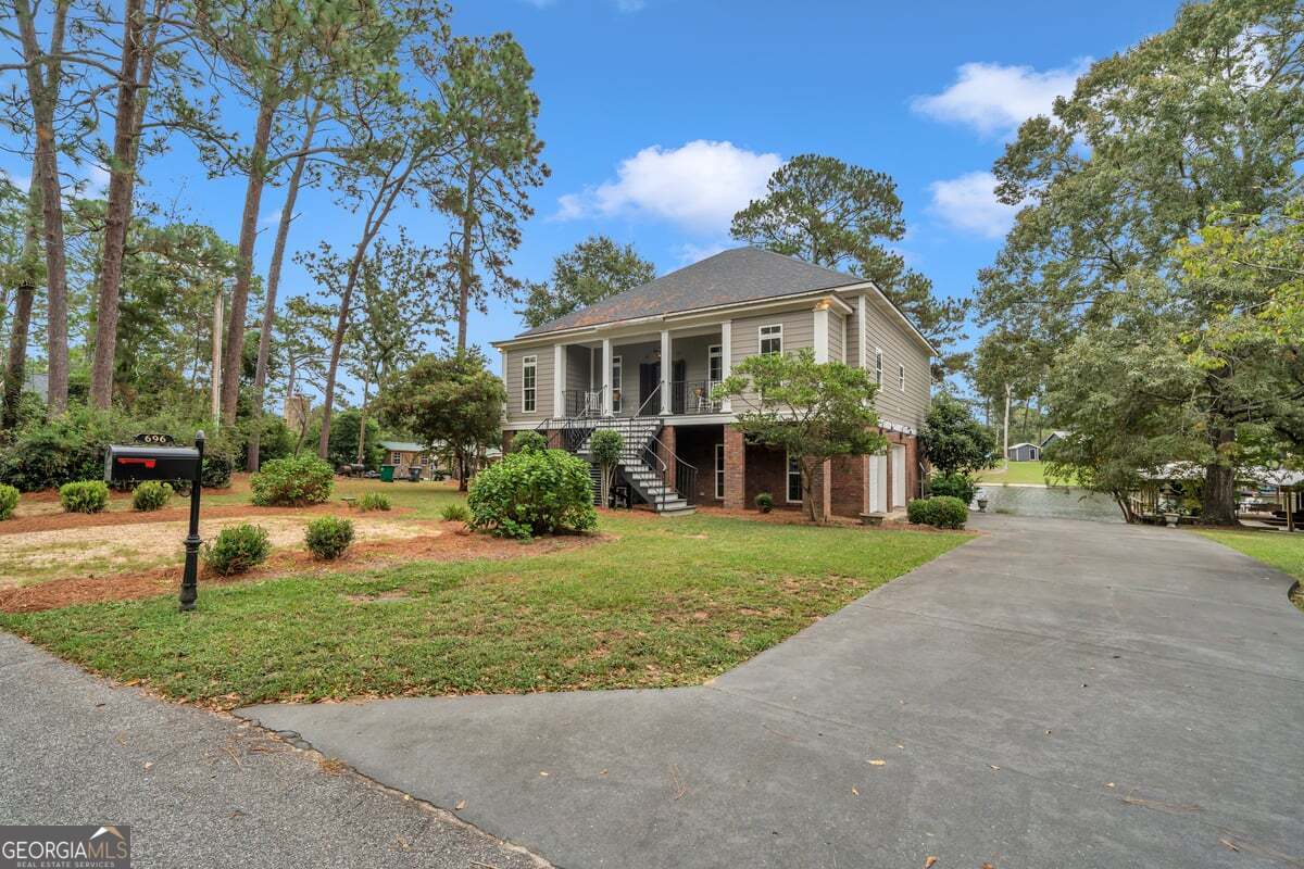 696 Cork Ferry Road Cordele, GA 31015 - Photo 3 of 79 a front view of a house with a yard