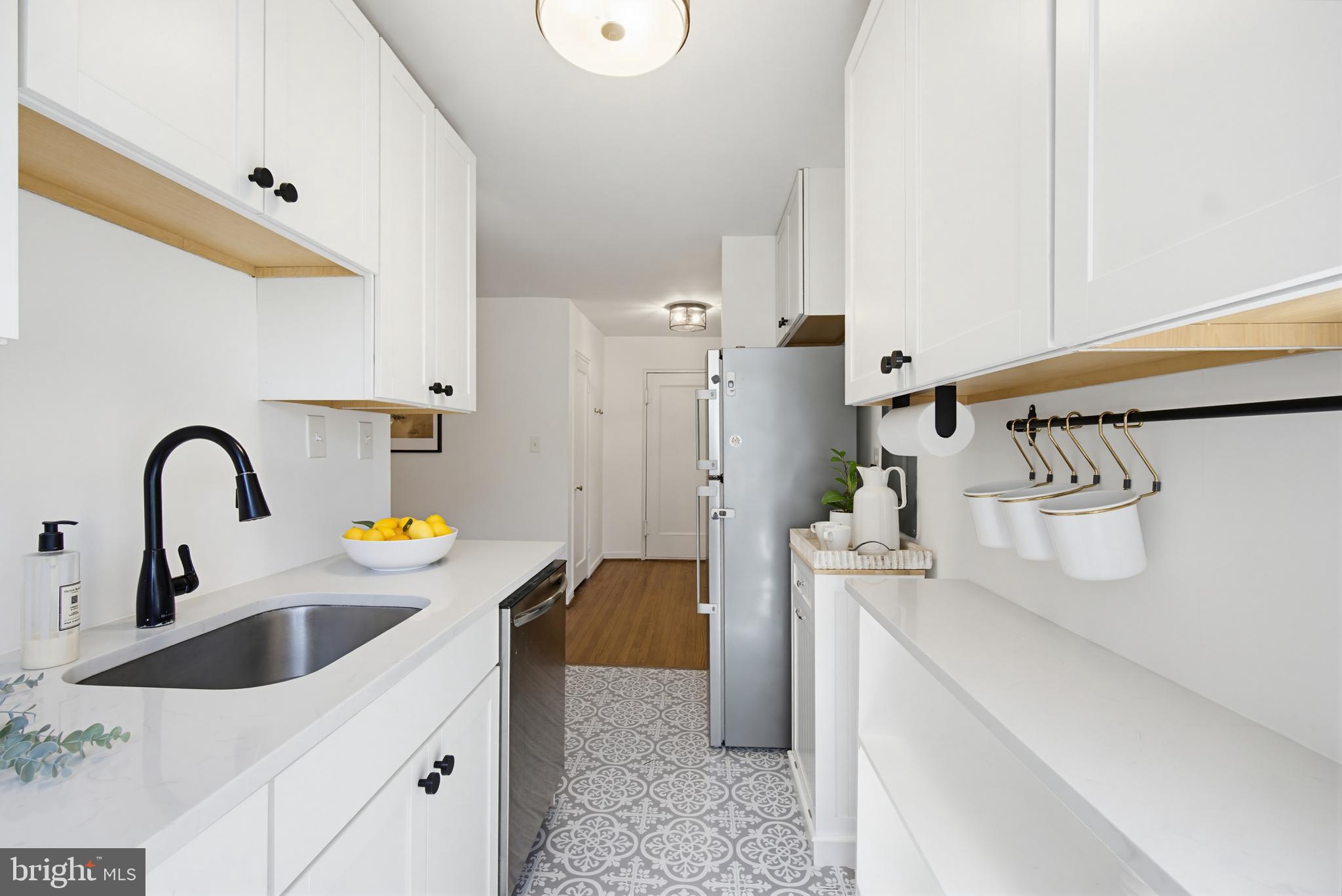 2214 Colston Drive, Unit 201 Silver Spring, MD 20910 - Photo 10 of 43 a kitchen with a sink and a refrigerator