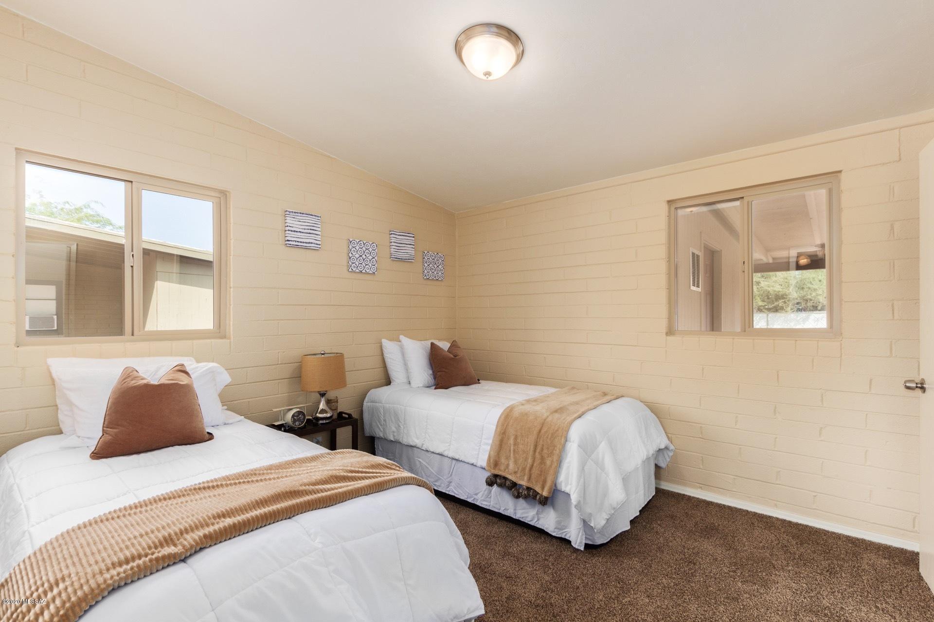 1043 East Navajo Road Tucson, AZ 85719 - Photo 20 of 25 a bedroom with two beds and painting on the wall