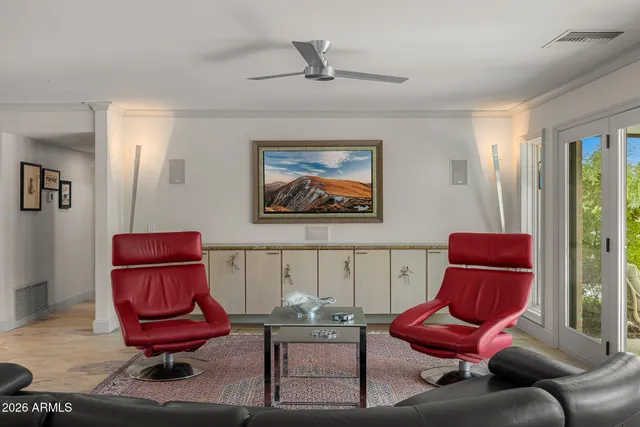 a living room with furniture and a chair