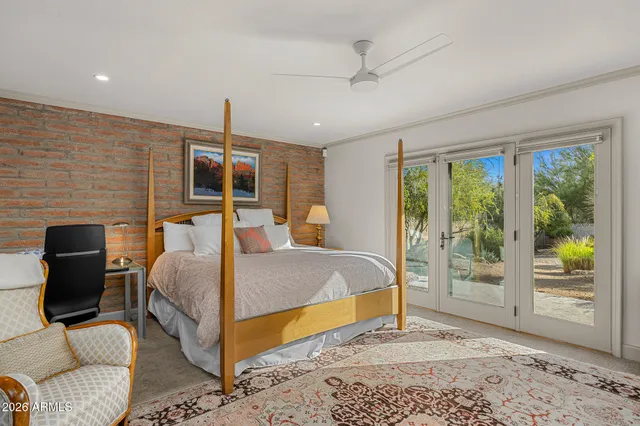 a bathroom with a double vanity sink a large mirror a shower and a bathtub