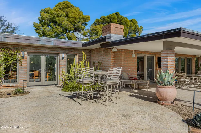 a view of a house with pool and a yard