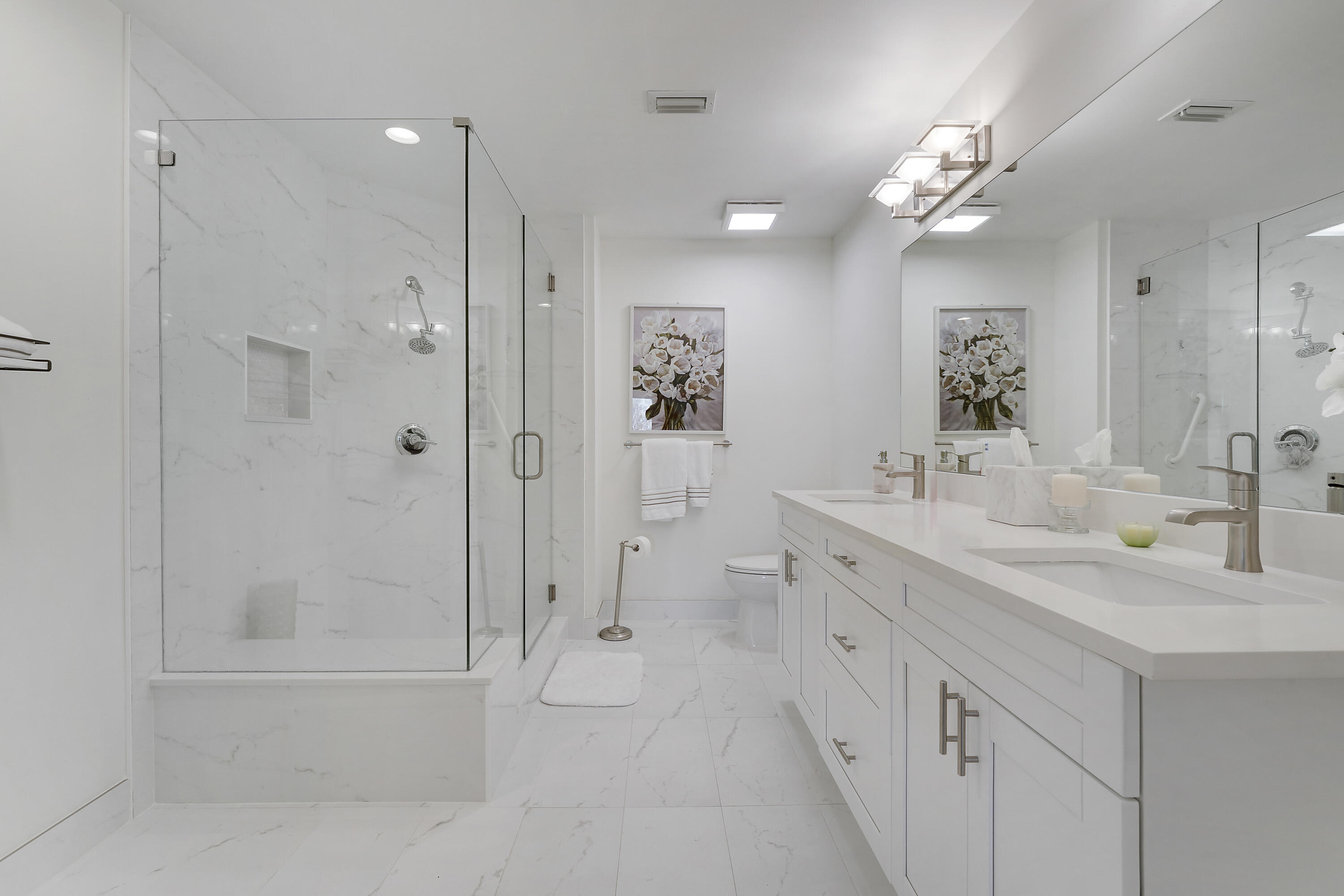 7860 Seville Place, Unit 2203 Boca Raton, FL 33433 - Photo 21 of 42 a bathroom with a double vanity sink mirror double and shower