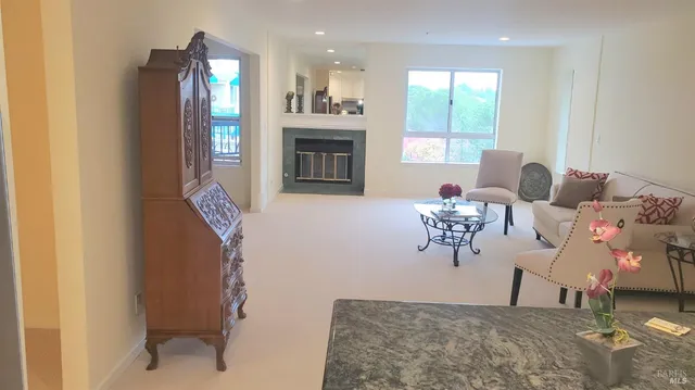 a living room with furniture a fireplace and a flat screen tv