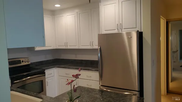 a kitchen with a refrigerator and cabinets