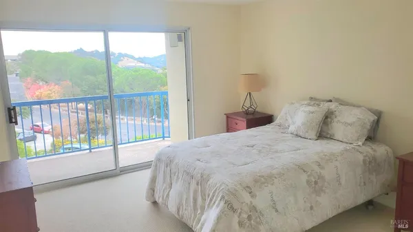 a large bed sitting in a bedroom next to a window