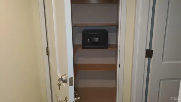 a view of a livingroom with wooden floor and a fireplace