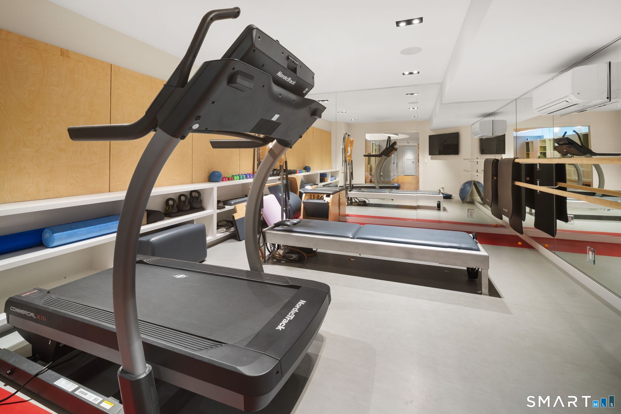 5 West Branch Road Weston, CT 06883 - Photo 35 of 40 a view of gym equipment and kitchen view