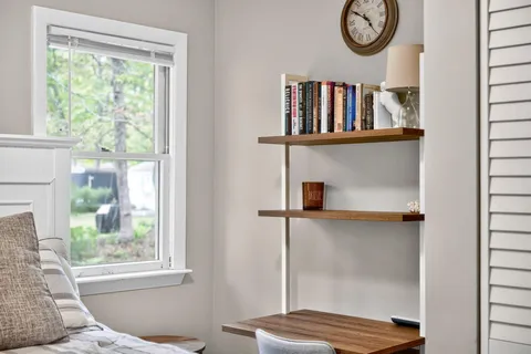 a view of a livingroom with wooden floor and a window