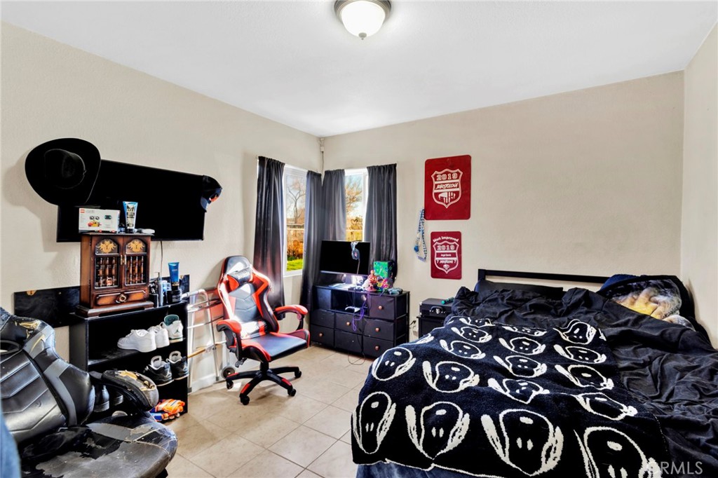 25466 Jasper Road Barstow, CA 92311 - Photo 15 of 22 a living room with furniture and a flat screen tv
