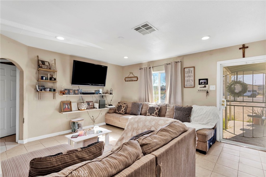 25466 Jasper Road Barstow, CA 92311 - Photo 3 of 22 a living room with furniture and a flat screen tv