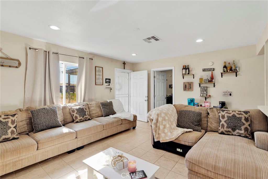 25466 Jasper Road Barstow, CA 92311 - Photo 6 of 22 a living room with furniture and a large window