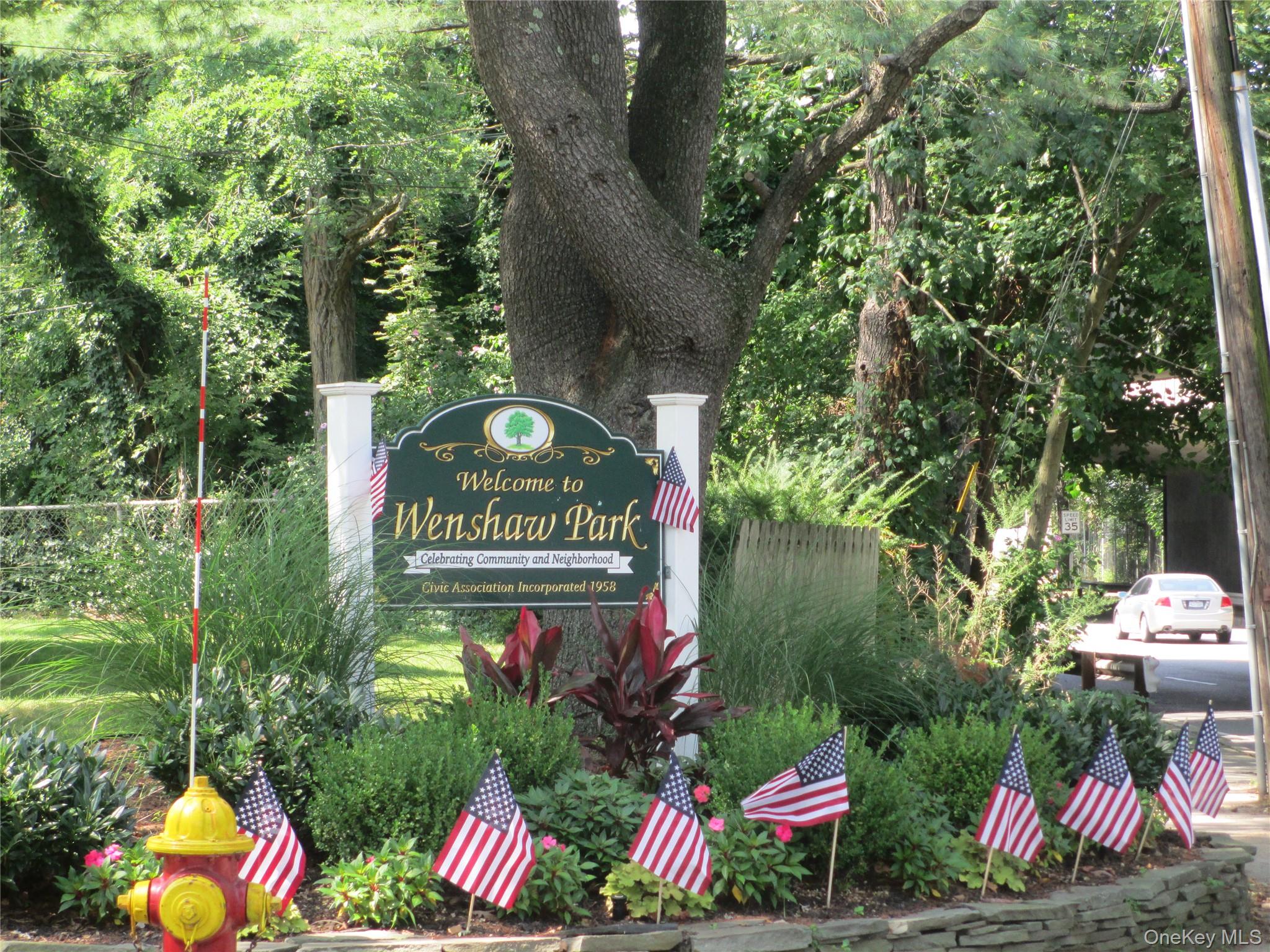a sign that is sitting in front of flowers
