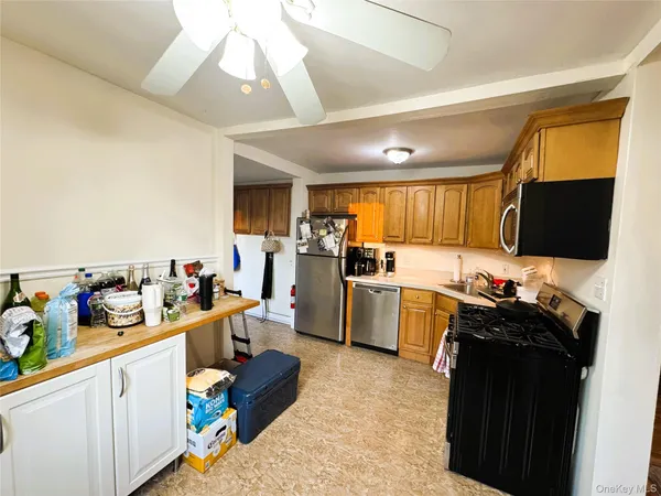 a kitchen with a sink dishwasher stove and refrigerator with wooden floor