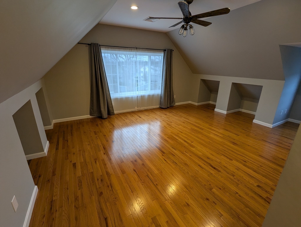 185 Mystic Street, Unit 2 Arlington, MA 02474 - Photo 12 of 33 wooden floor in an empty room with a window