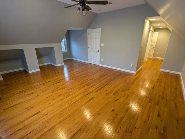 a view of a room with wooden floor