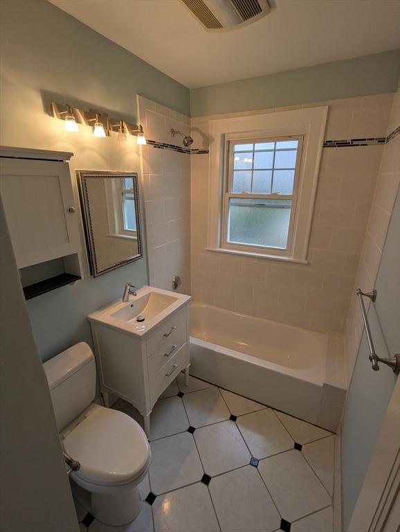 185 Mystic Street, Unit 2 Arlington, MA 02474 - Photo 29 of 33 a bathroom with a toilet sink and mirror