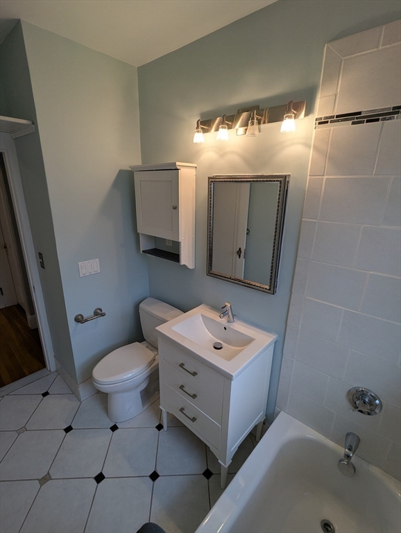 185 Mystic Street, Unit 2 Arlington, MA 02474 - Photo 30 of 33 a bathroom with a toilet sink and mirror