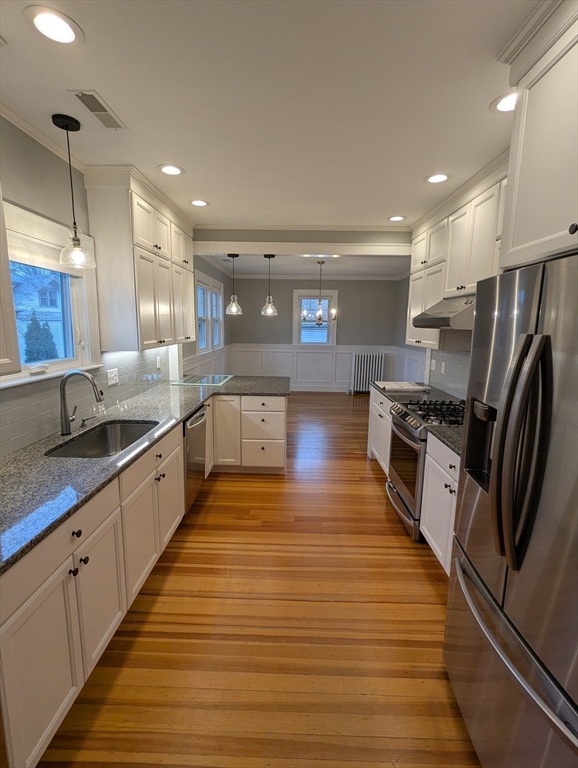 185 Mystic Street, Unit 2 Arlington, MA 02474 - Photo 3 of 33 a large kitchen with stainless steel appliances granite countertop a lot of counter space