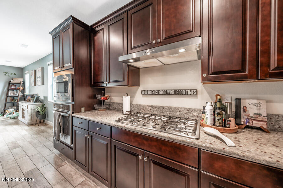 2745 Trail Rider Drive Reno, NV 89521 - Photo 11 of 50 a kitchen with stainless steel appliances granite countertop a sink stove and cabinets