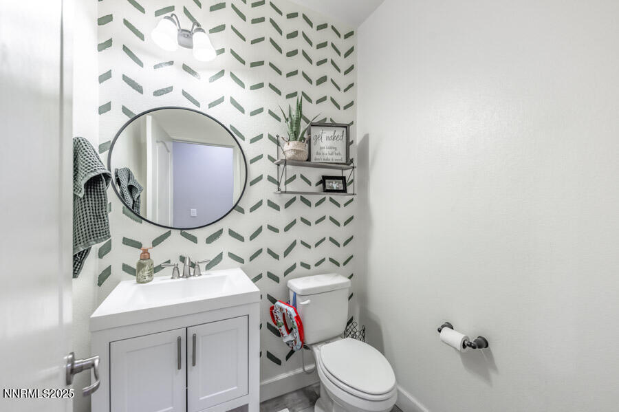 2745 Trail Rider Drive Reno, NV 89521 - Photo 32 of 50 a bathroom with a granite countertop toilet sink mirror and vanity