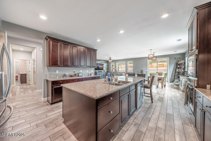 2745 Trail Rider Drive Reno, NV 89521 - Photo 10 of 50 a kitchen with a sink stove cabinets and wooden floor