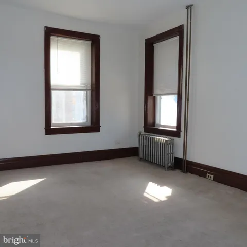 a view of empty room with wooden walls