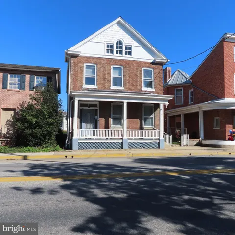 a view of lobby with a rug and a floor to ceiling window