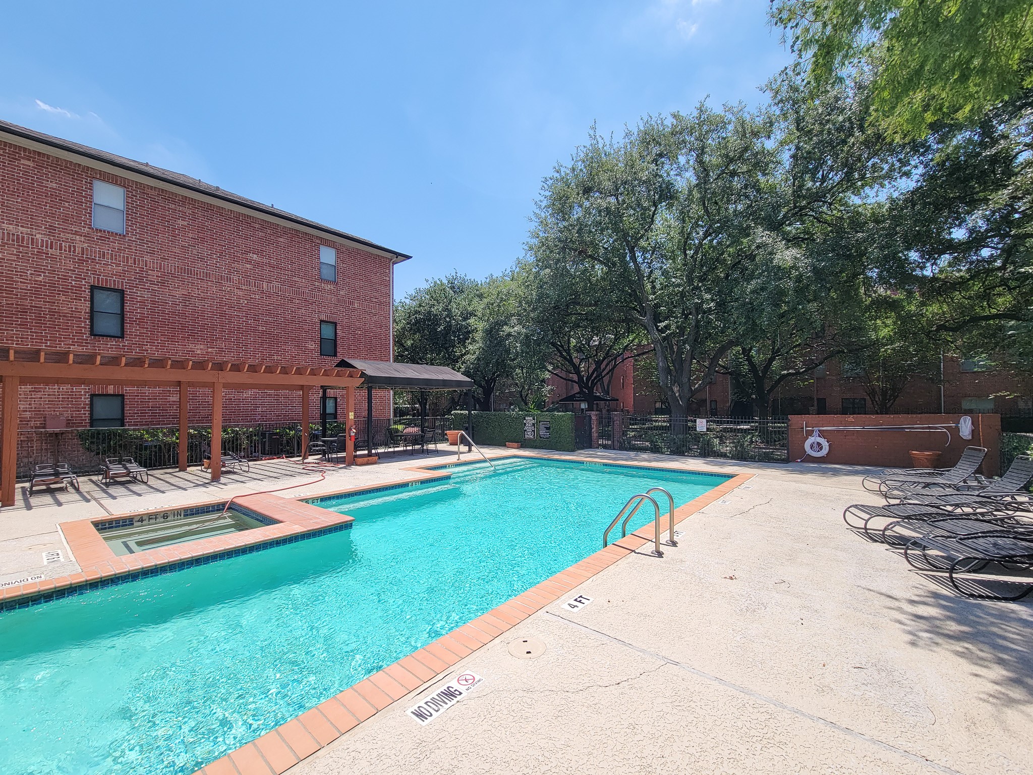 4041 Drake Street, Unit 116 Houston, TX 77005 - Photo 27 of 27 a view of swimming pool with lawn chairs and plants