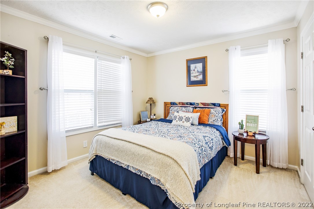 1909 Yellowbrick Road Fayetteville, NC 28314 - Photo 18 of 25 a bedroom with a bed and a night stand