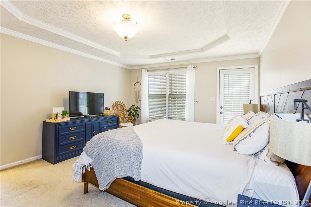 1909 Yellowbrick Road Fayetteville, NC 28314 - Photo 20 of 25 a bedroom with a bed and a chandelier