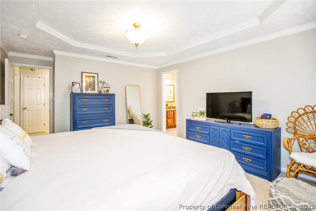 1909 Yellowbrick Road Fayetteville, NC 28314 - Photo 21 of 25 a bedroom with a bed and a flat screen tv