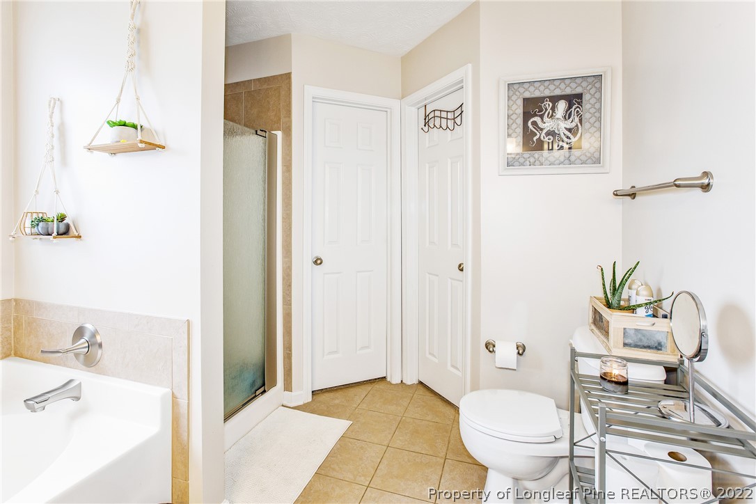 1909 Yellowbrick Road Fayetteville, NC 28314 - Photo 23 of 25 a bathroom with a sink toilet and shower