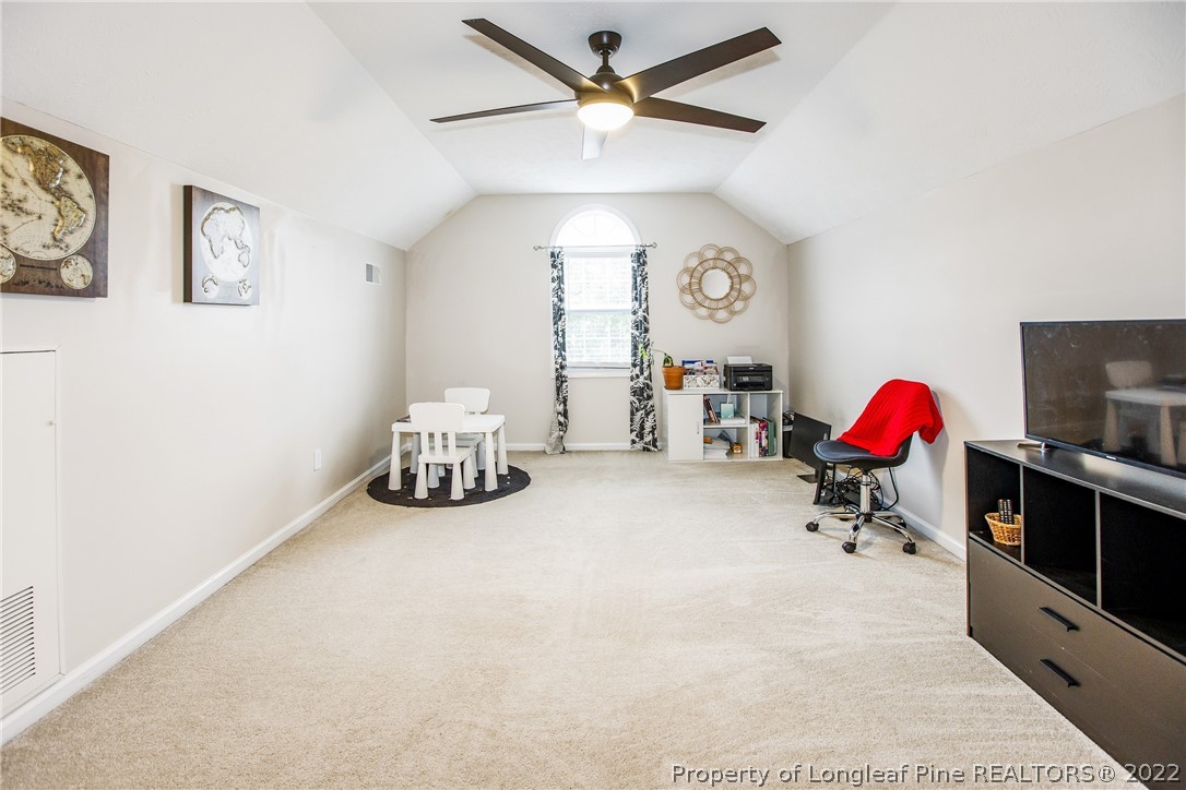 1909 Yellowbrick Road Fayetteville, NC 28314 - Photo 24 of 25 a living room with furniture gym equipment and a rug