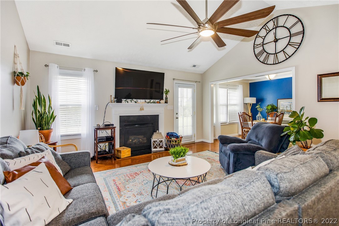 1909 Yellowbrick Road Fayetteville, NC 28314 - Photo 5 of 25 a living room with furniture a flat screen tv and a fireplace
