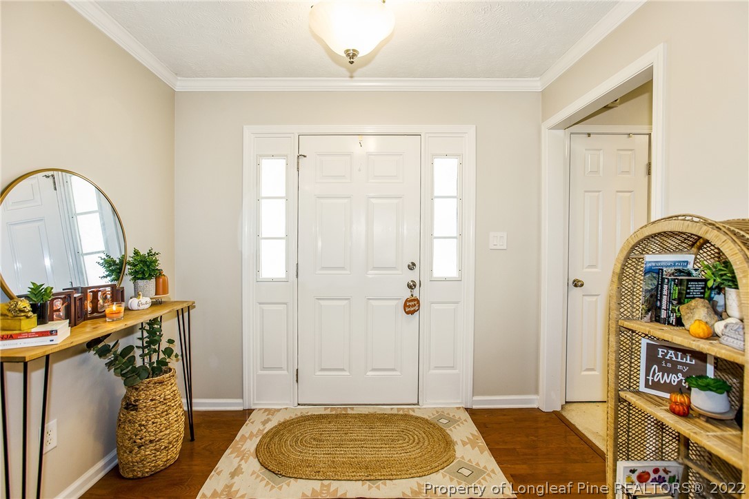 1909 Yellowbrick Road Fayetteville, NC 28314 - Photo 6 of 25 a bedroom with a bed and a table in it