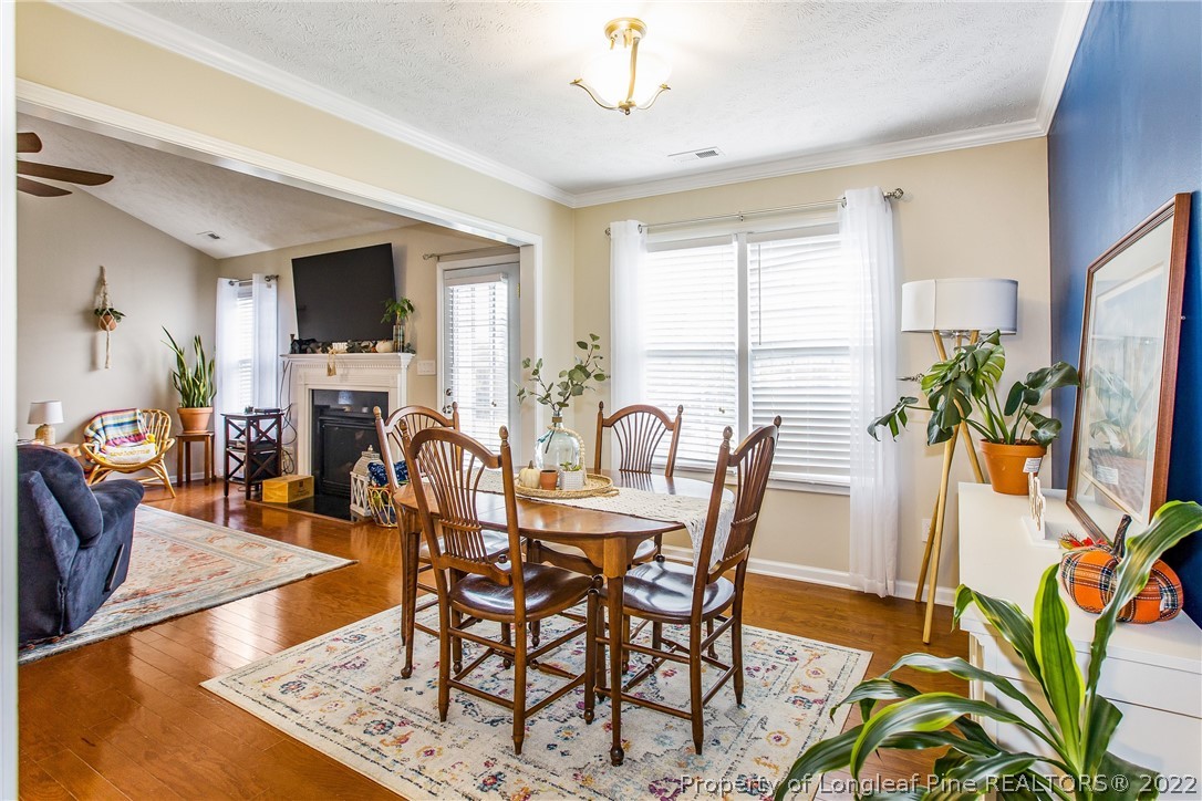 1909 Yellowbrick Road Fayetteville, NC 28314 - Photo 10 of 25 a view of a dining room with furniture window and wooden floor