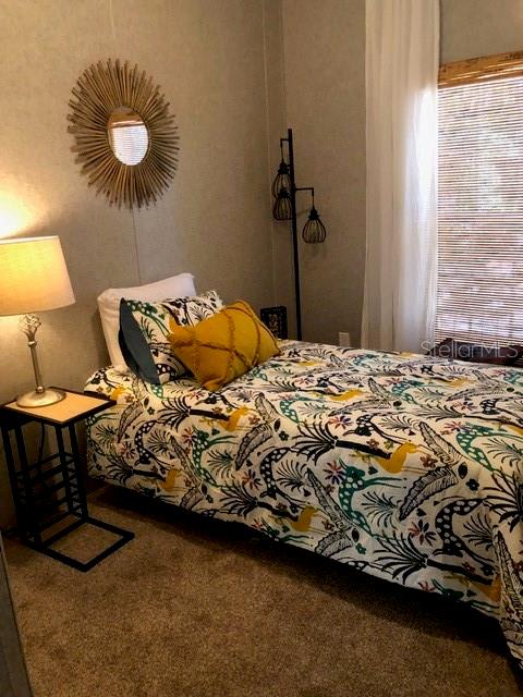 101 Tomahawk Road Hawthorne, FL 32640 - Photo 19 of 25 a bedroom with a bed and a lamp on the table