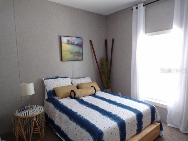 101 Tomahawk Road Hawthorne, FL 32640 - Photo 20 of 25 a bedroom with a bed and a flat screen tv