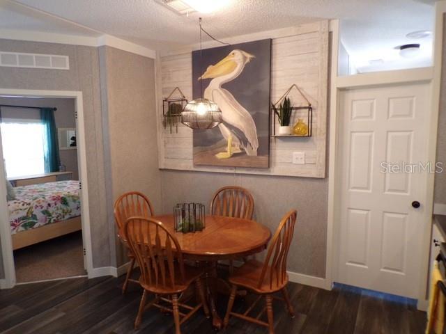 101 Tomahawk Road Hawthorne, FL 32640 - Photo 9 of 25 a view of a dining room with furniture and wooden floor