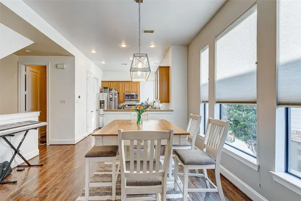 a view of a dining room with furniture window and wooden floor