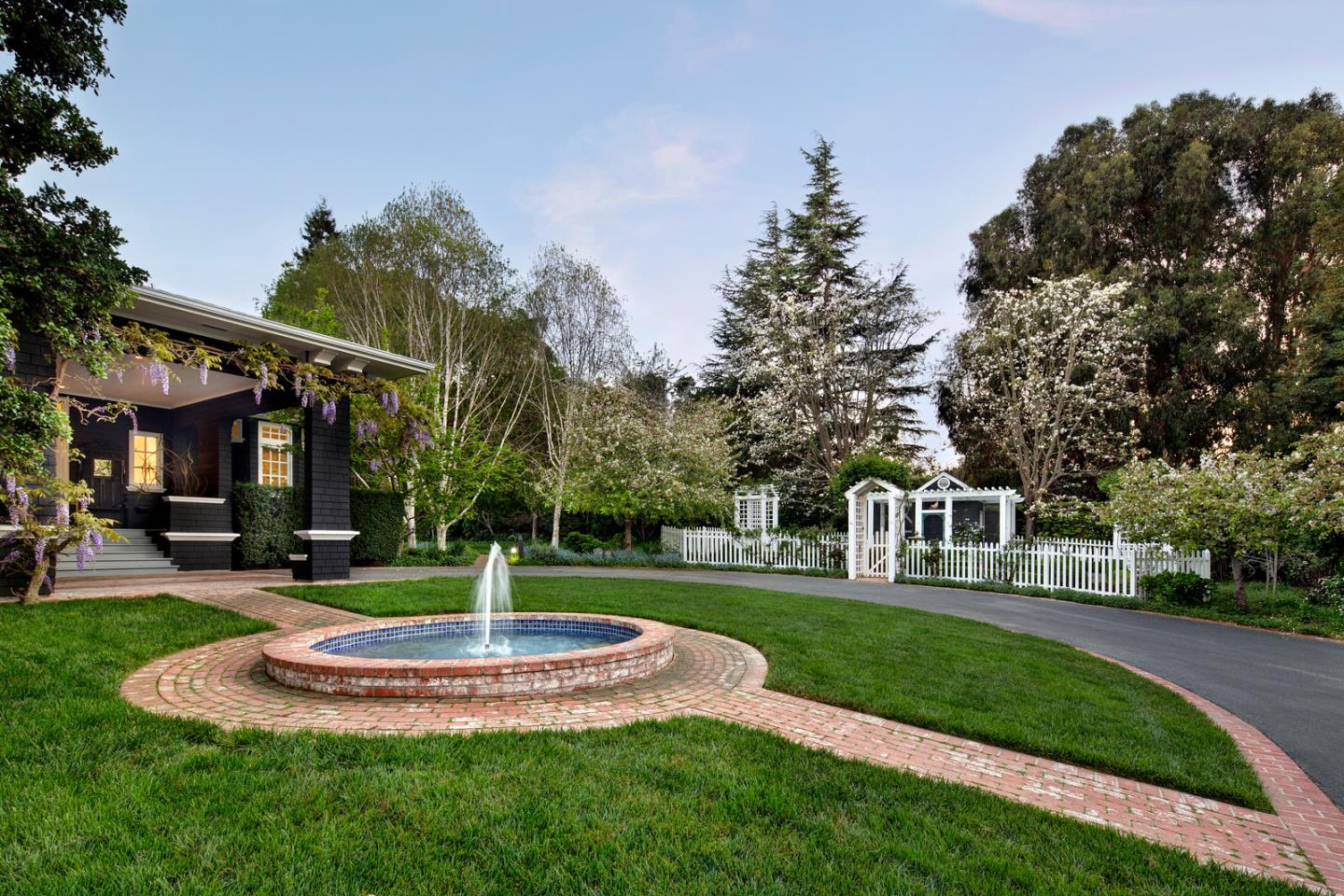 137 Moore Road Woodside, CA 94062 - Photo 3 of 22 a front view of a house with a yard table and chairs