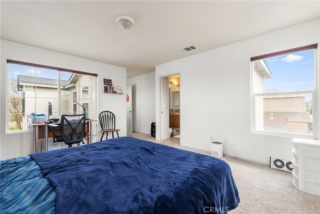 4357 Mathias Way Merced, CA 95348 - Photo 13 of 32 a bed sitting in a bedroom next to a window