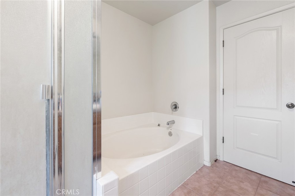 4357 Mathias Way Merced, CA 95348 - Photo 16 of 32 a white bath tub sitting next to a white wooden vanity