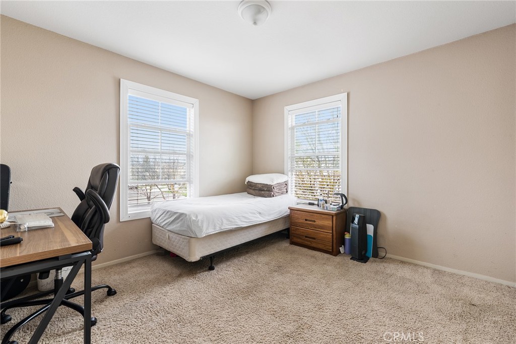 4357 Mathias Way Merced, CA 95348 - Photo 18 of 32 a bedroom with a bed and a desk