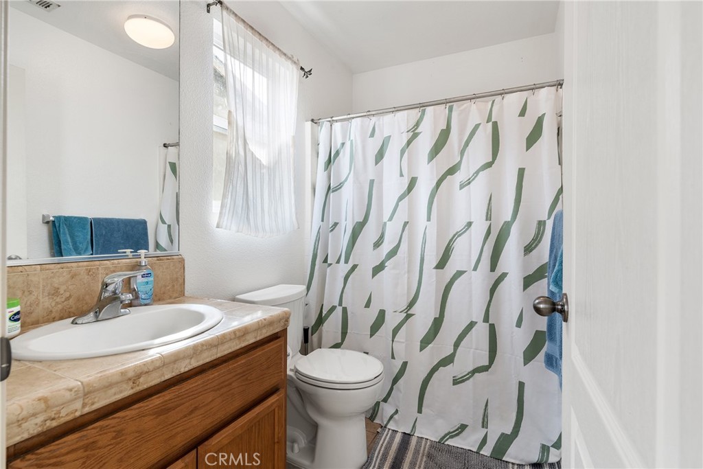 4357 Mathias Way Merced, CA 95348 - Photo 20 of 32 a bathroom with a granite countertop sink and a mirror
