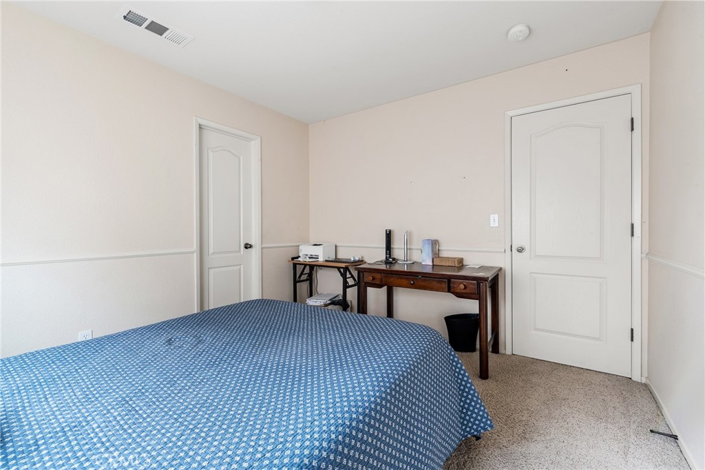 4357 Mathias Way Merced, CA 95348 - Photo 23 of 32 a bedroom with a bed and a table