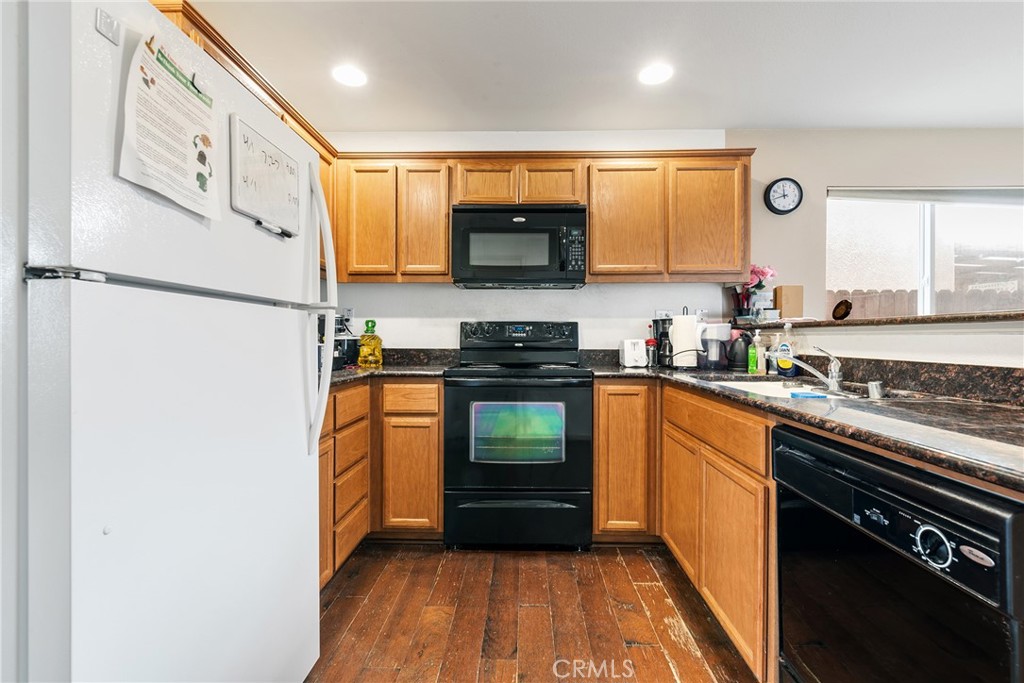 4357 Mathias Way Merced, CA 95348 - Photo 8 of 32 a kitchen with granite countertop stainless steel appliances a refrigerator a stove top oven and sink
