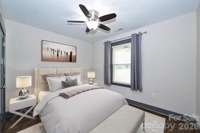 a bedroom with a large bed and a window